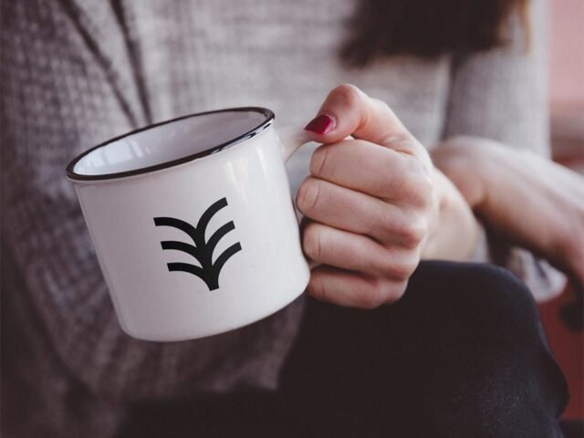 Hand Holding Metal Mug Mockup