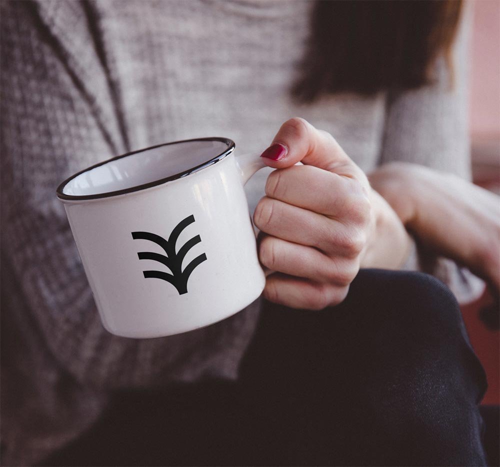 Hand Holding Metal Mug Mockup